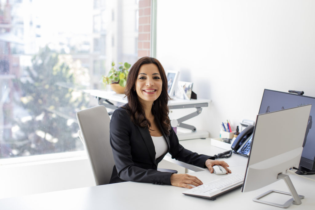 Leena Yousefi at her desk at the YLaw office in Vancouver.